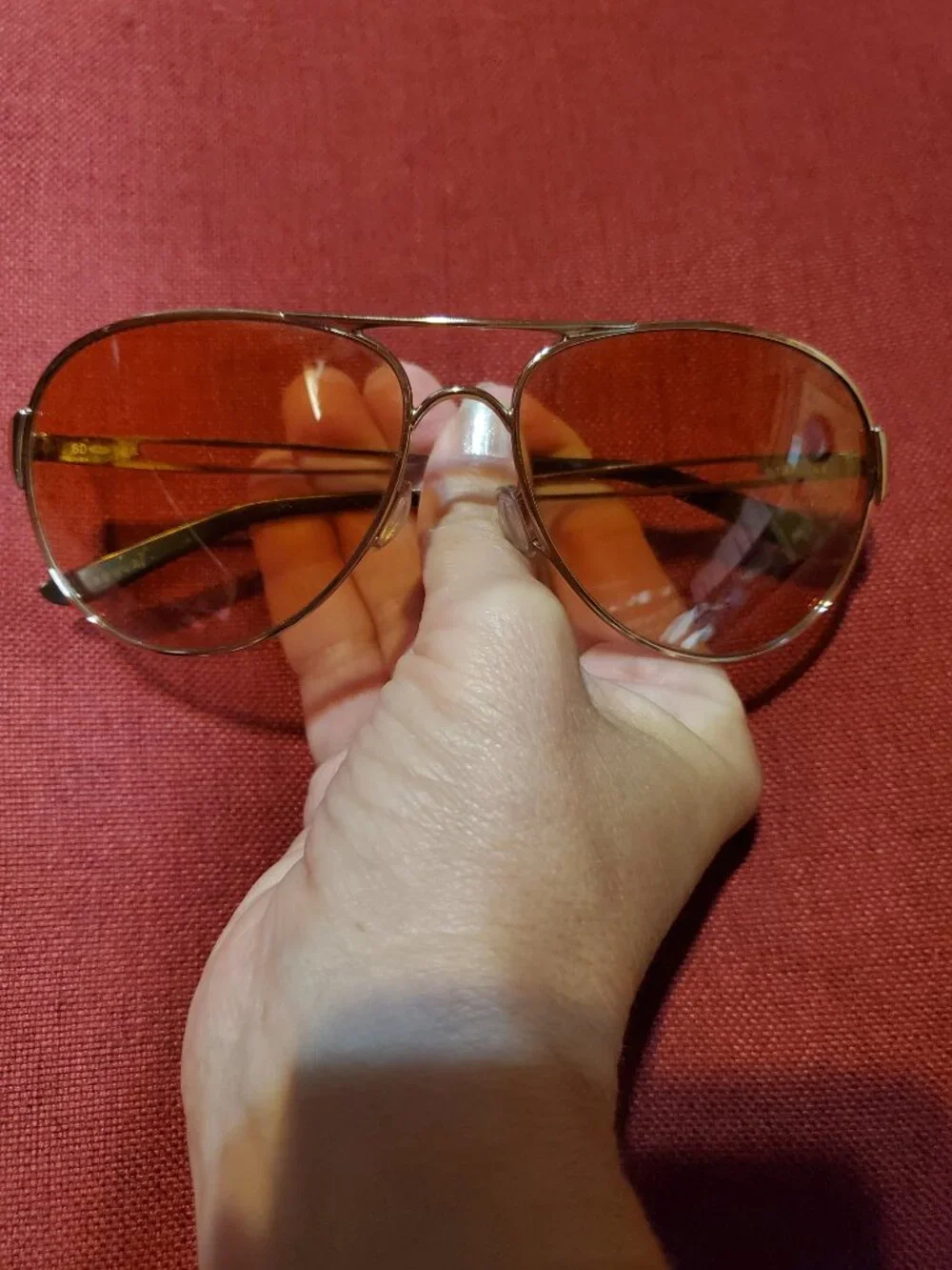 Oakley Caveat aviator sunglasses featuring a rose gold metal frame and warm brow